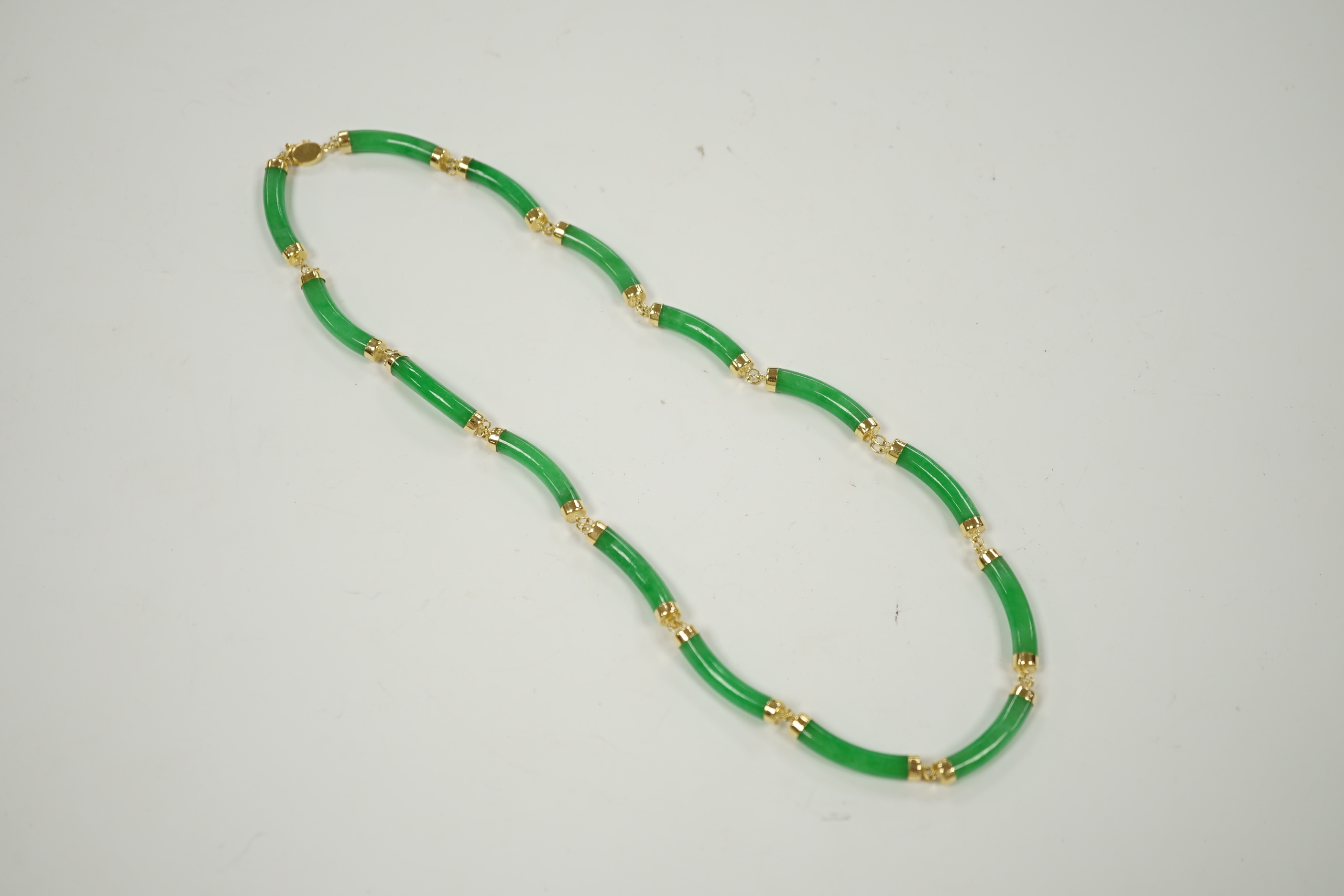 A 14k yellow metal and curved jade link necklace, 42cm, gross weight 25 grams.